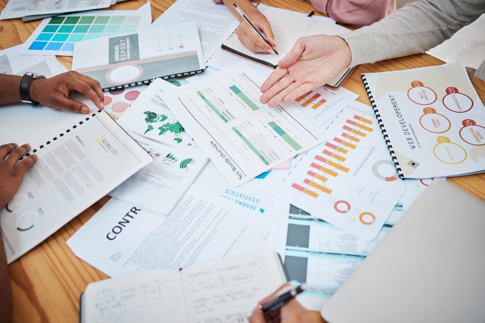 A desk with printed carbon market charts and reports