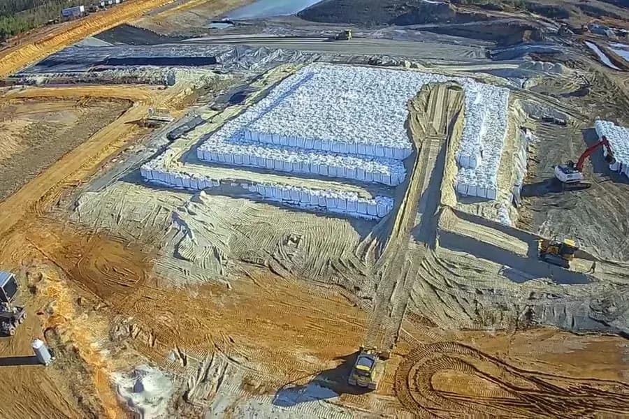 Aerial view of wrapped Carbon Casting blocks stacked in Graphyte’s lined storage chamber