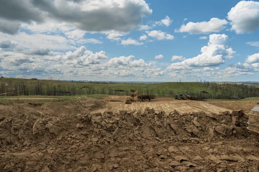 Excavators preparing the MT1 burial chamber below burned Montana hillsides