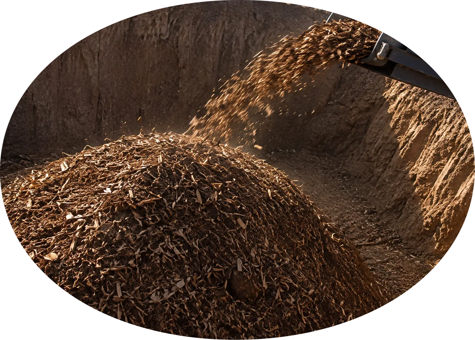 Wood chips pouring from a conveyor into an engineered storage pit